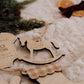 Ornement personnalisé - Formes : cheval à bascule Caleb au centre, près d’un bas de Noël à revers à carreaux.