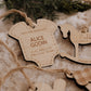Ornement personnalisé - Cache couche : modèle Alice Godin avec cordon de jute, parmi d’autres ornements en bois.